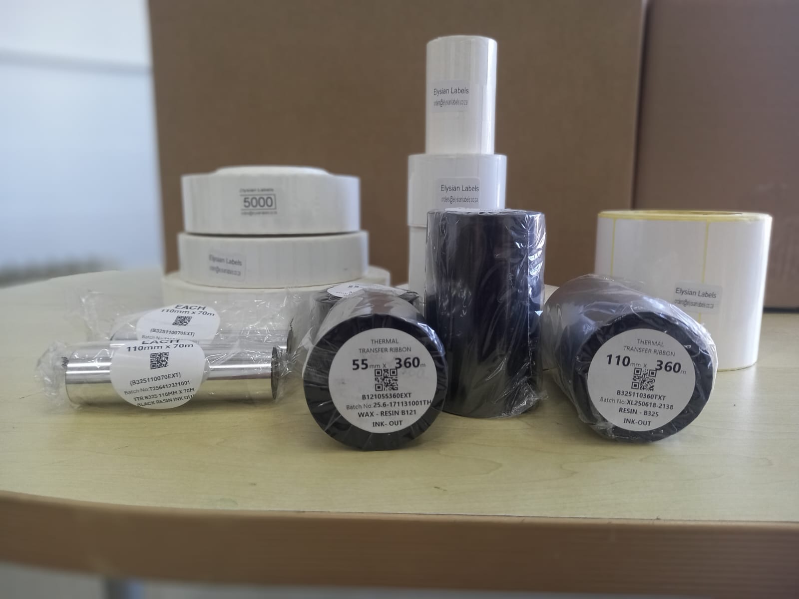 Elysian Labels thermal transfer rolls with wax-resin and resin ribbons alongside